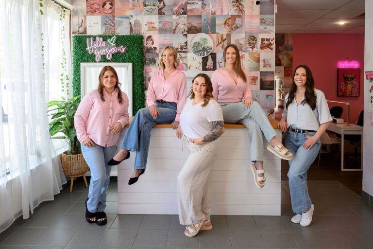 Group of 5 women in white and light pink shirts
